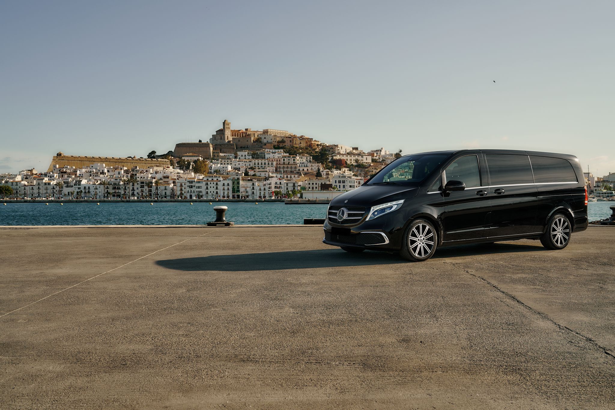 Van in Ibiza with old town in the landscape